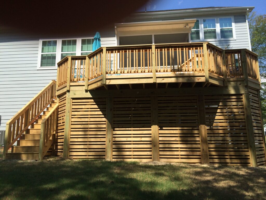 Wood deck with functional storage wall for a neat and organized outdoor space.