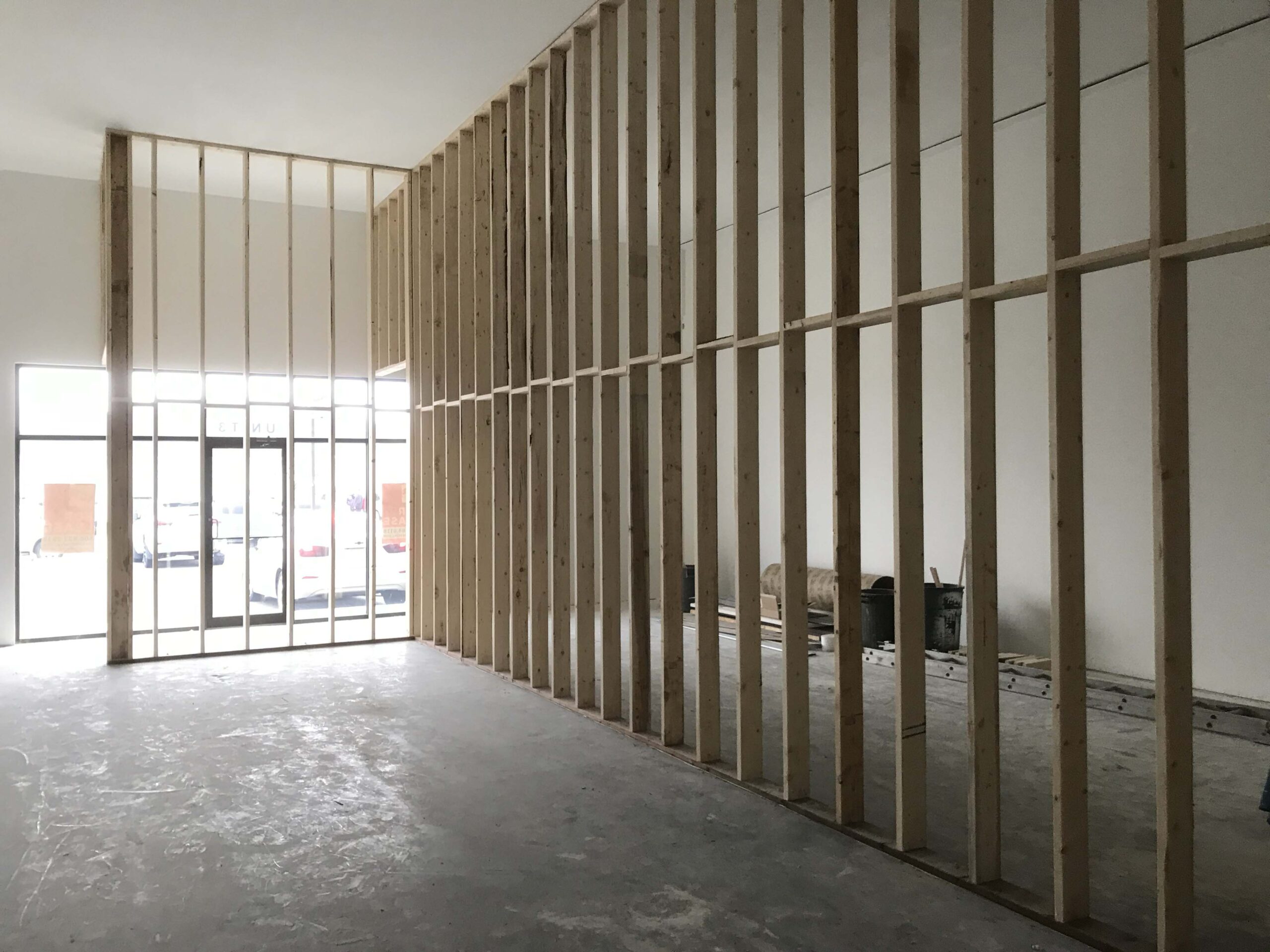 Interior construction space with high ceilings and wooden framing, showcasing Alberta Builder Services' expertise in custom commercial building solutions.