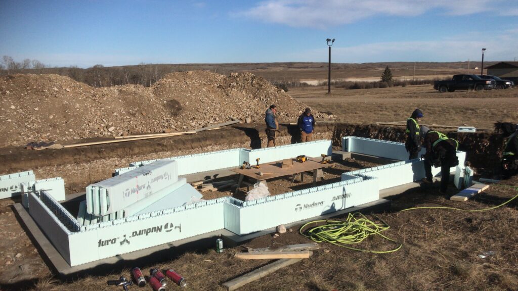 Construction crew working on an ICF foundation system for a custom project by Alberta Builder Services.