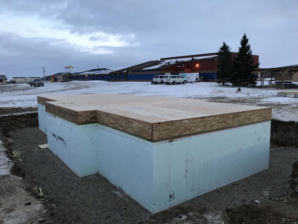 Insulated concrete form (ICF) foundation with a floor system installed, prepared for the next phase of construction by Alberta Builder Services.