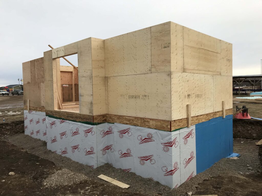 Partially completed building with an ICF foundation and framed wooden walls, showcasing Alberta Builder Services' expertise in custom construction.