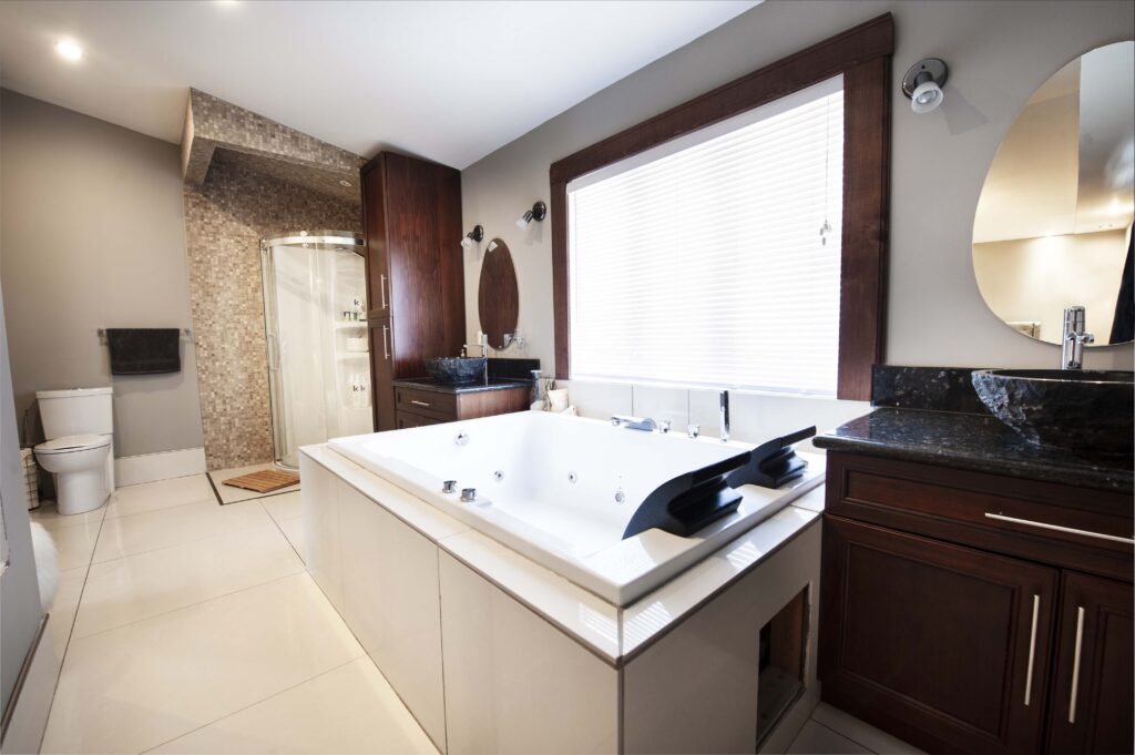 Luxurious master bathroom with a corner shower, dark wood cabinetry, and a large soaking tub.