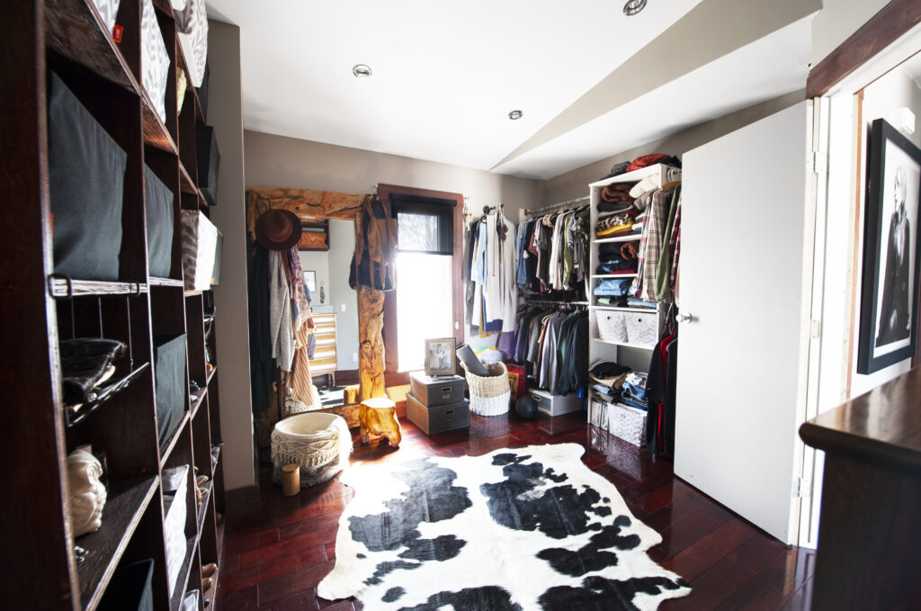 Spacious walk-in closet with custom shelving, hanging space, and natural light.