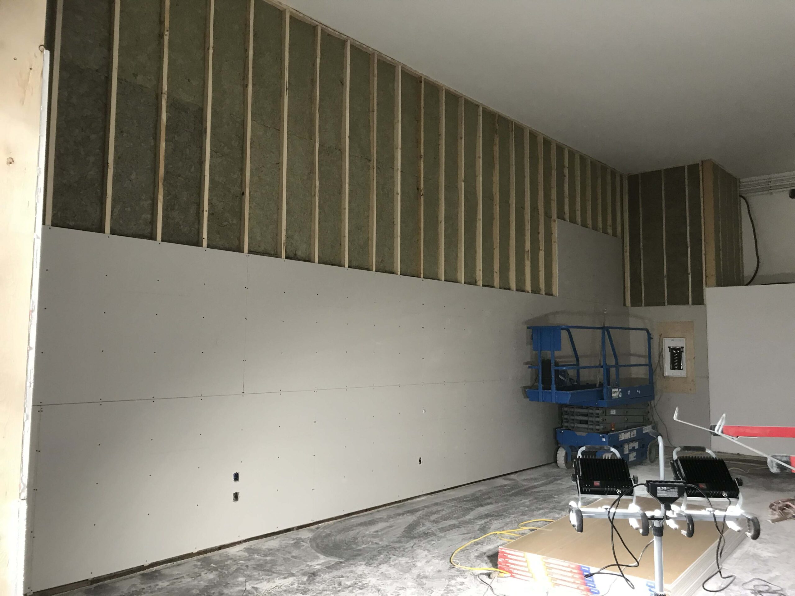 Partially drywalled commercial space with insulation installed, showcasing Alberta Builder Services' professional construction capabilities.