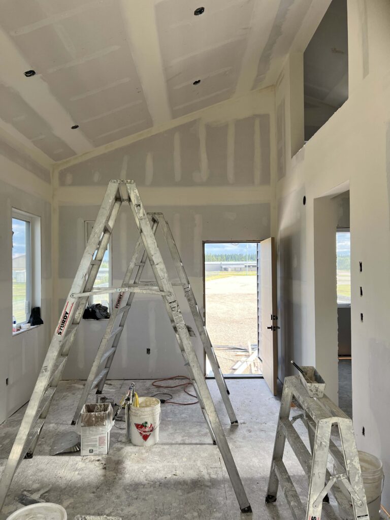 Finished room with sloped ceilings and taped, mudded drywall, showcasing Alberta Builder Services' expertise in residential construction.