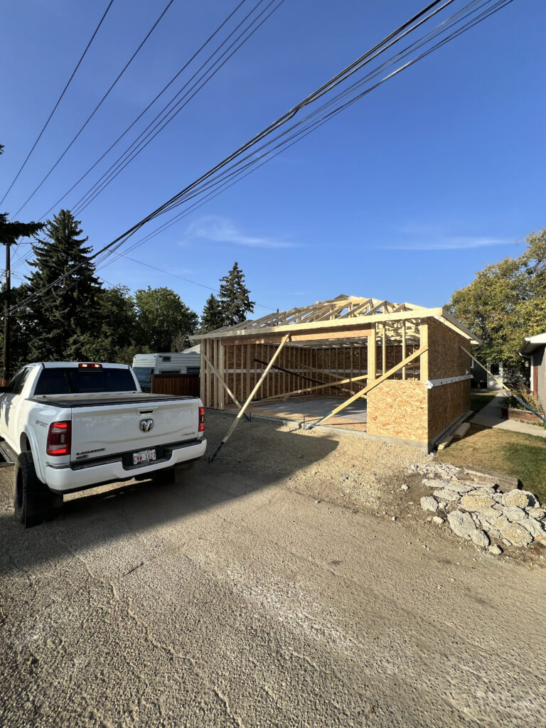 Framing and roof truss installation underway for a detached garage in Edmonton, built by Alberta Builder Services Ltd.