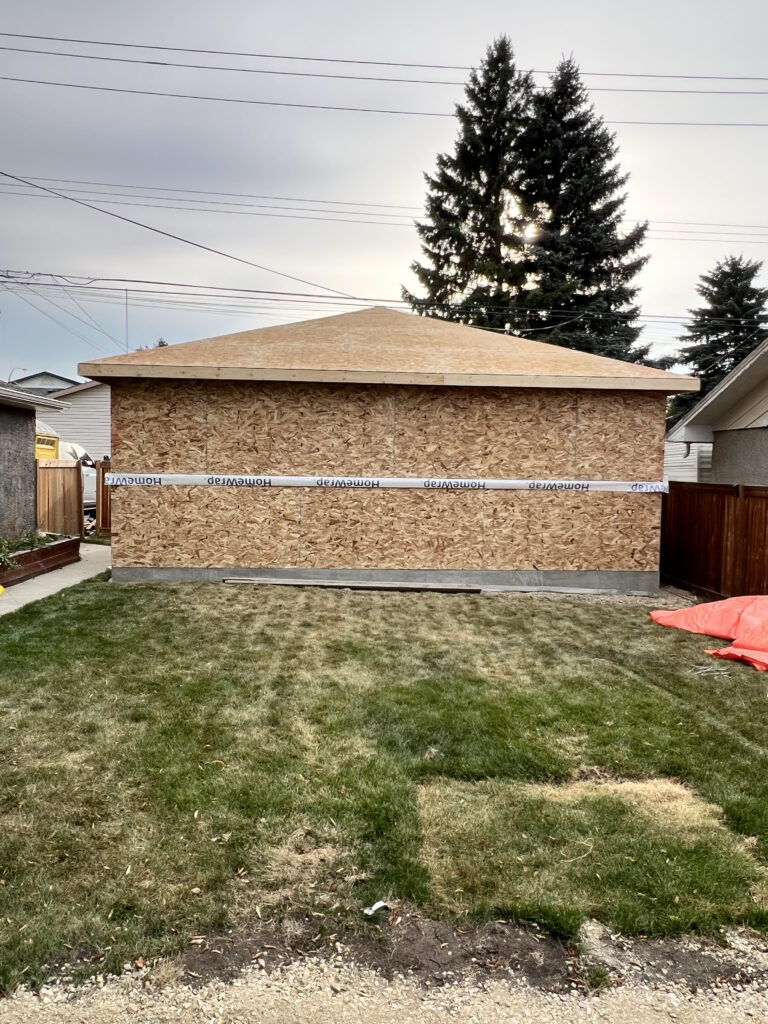 Detached garage in Edmonton with completed roof sheathing and exterior wall sheathing installed by Alberta Builder Services Ltd.