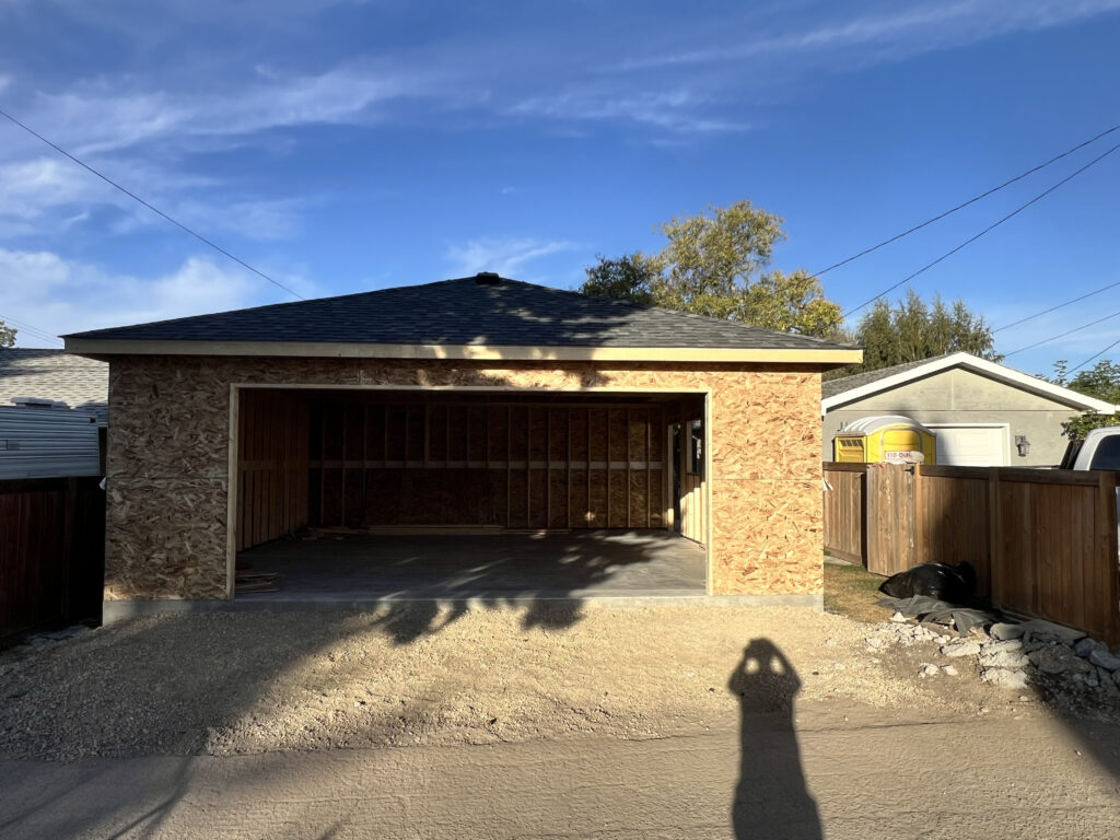 Detached garage in Edmonton with completed shingled roof and full structural framing by Alberta Builder Services Ltd.