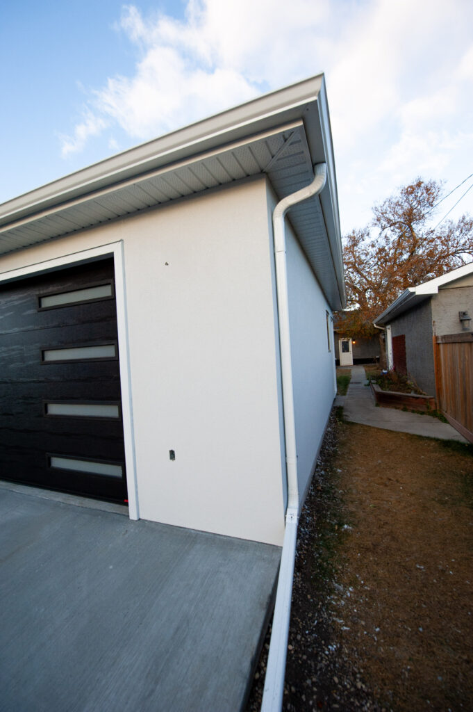 Close-up view of a textured acrylic stucco exterior wall on a newly finished garage.