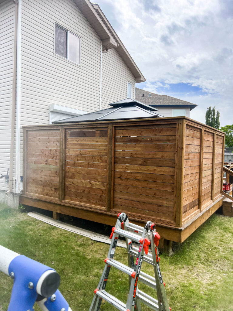Fully enclosed backyard deck with privacy wall and metal gazebo in Edmonton, built by Alberta Builder Services Ltd.