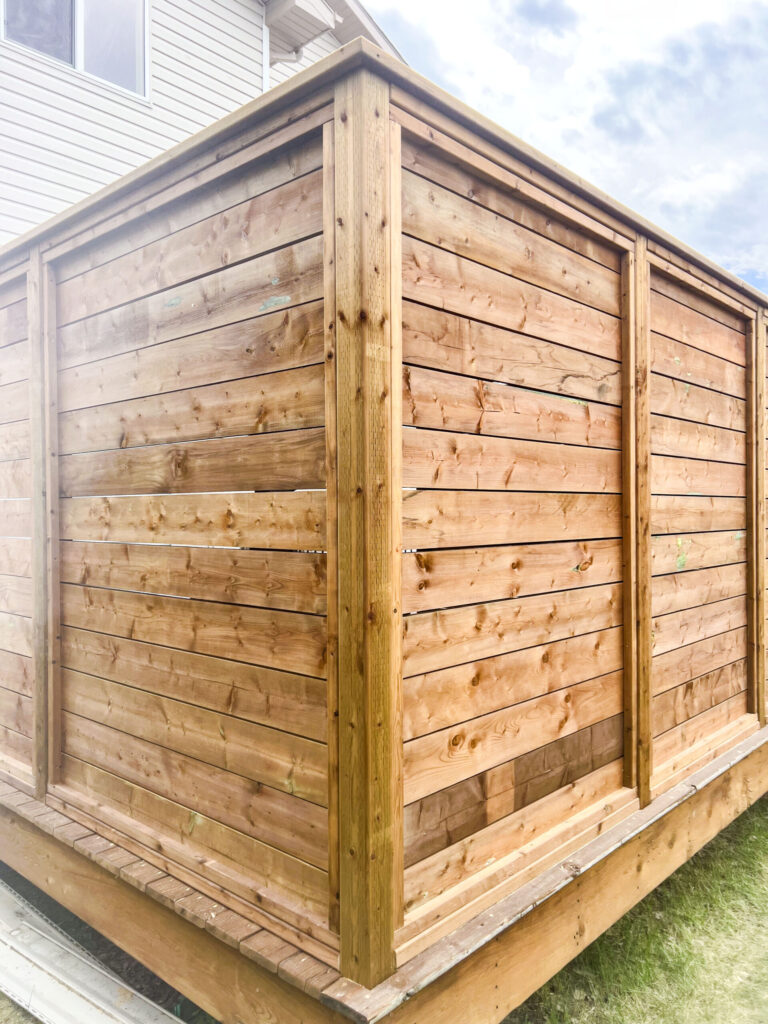 Close-up view of a custom wood privacy wall enclosure on a raised deck in Edmonton, built by Alberta Builder Services Ltd.