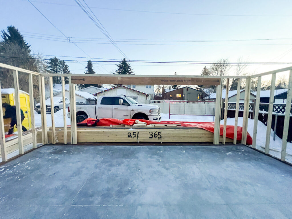 Early garage framing stage in Edmonton showing wall framing and sill plates on a concrete slab by Alberta Builder Services