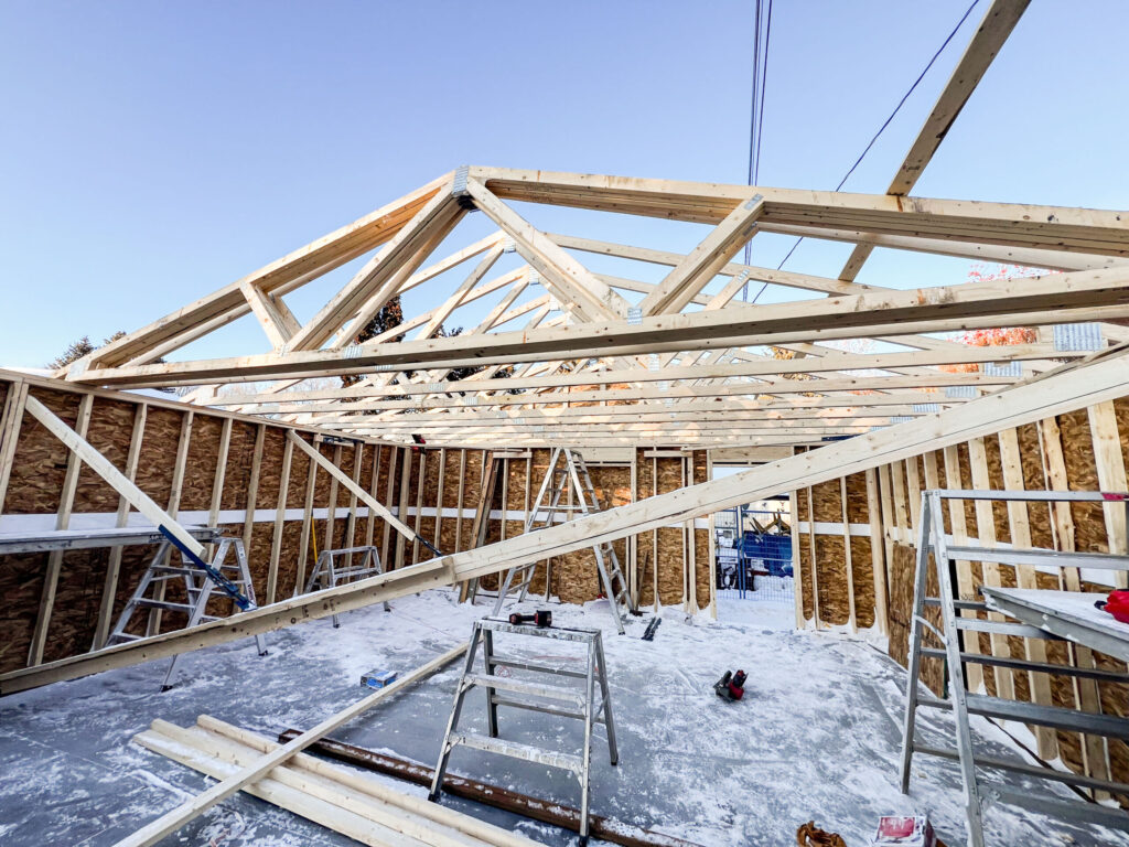 Garage roof framing in progress in Edmonton showing engineered trusses installed over framed walls by Alberta Builder Services