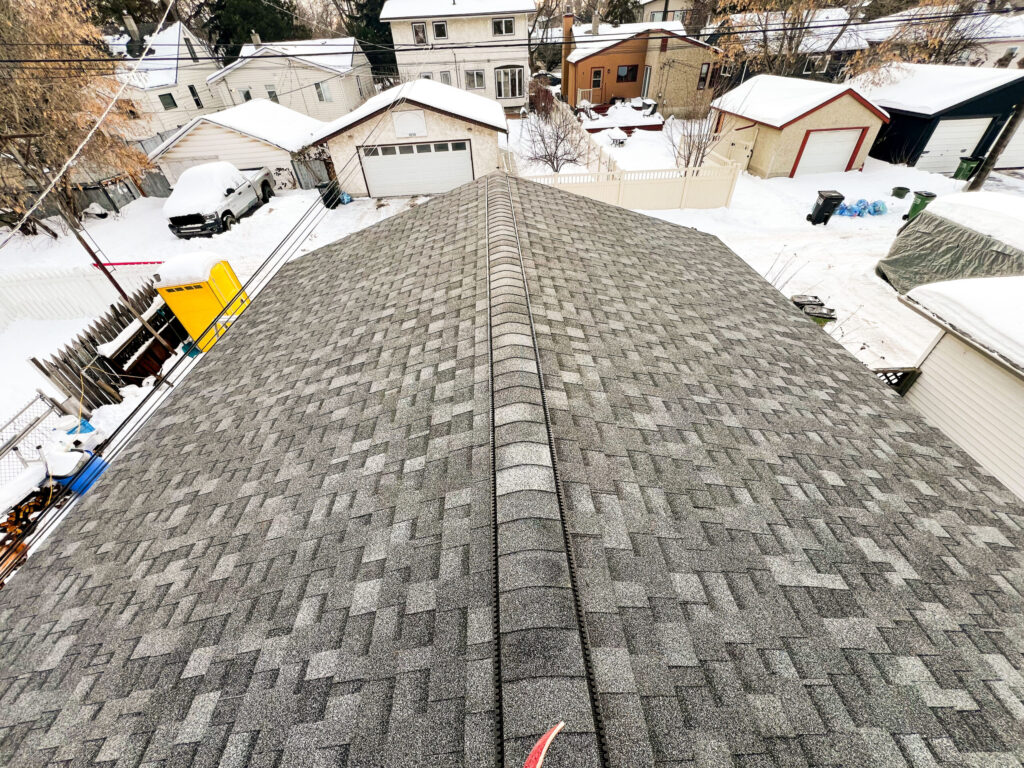 Completed detached garage roof in Edmonton with asphalt shingles and ridge vent installed by Alberta Builder Services
