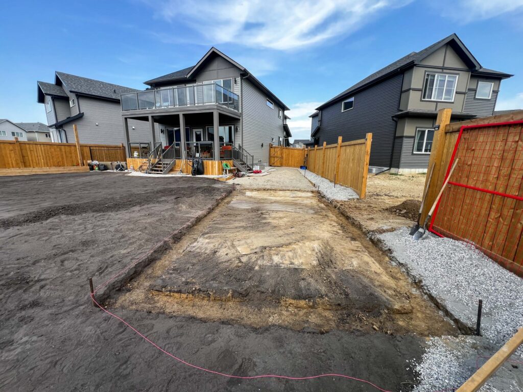 Excavation and site preparation for a custom oversized detached backyard shed foundation in the Greater Edmonton area by Alberta Builder Services Ltd.