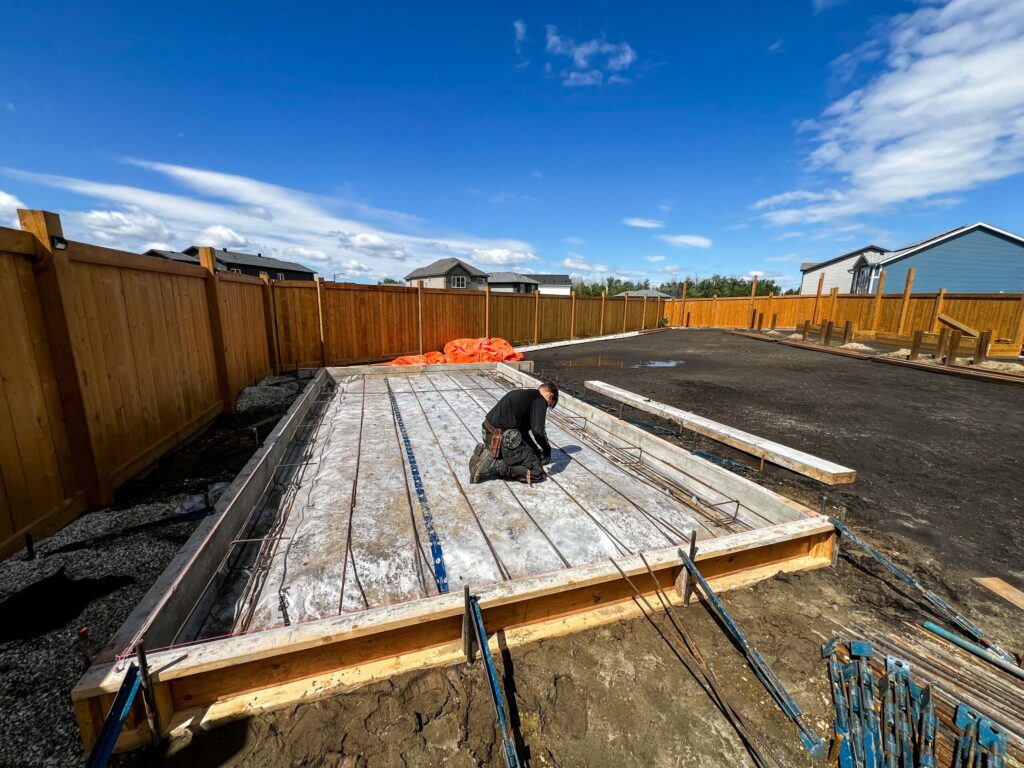 Reinforced concrete slab preparation for a custom oversized detached backyard shed in the Greater Edmonton area by Alberta Builder Services Ltd.