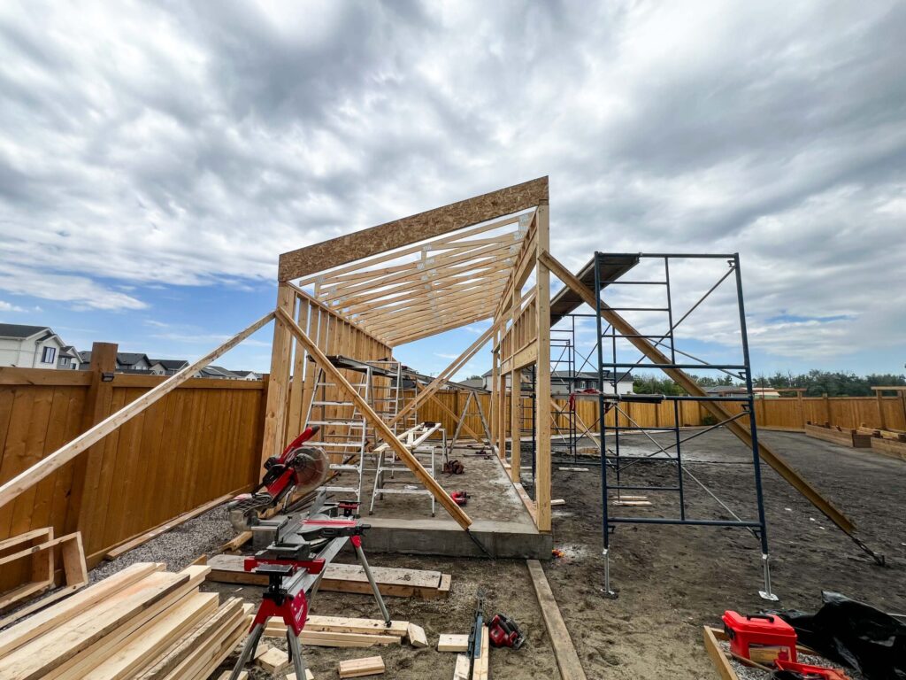 Custom oversized detached backyard shed during structural framing with engineered shed roof in the Greater Edmonton area by Alberta Builder Services Ltd.