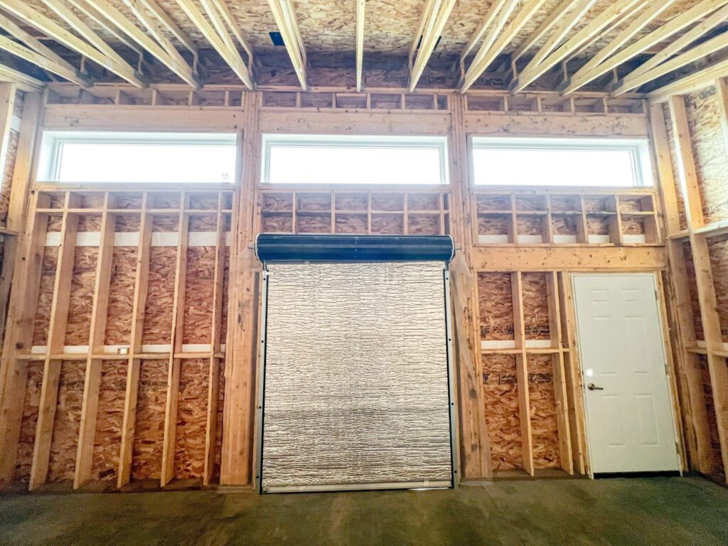 Interior framing of a custom oversized detached backyard shed with vaulted ceiling and transom windows in the Greater Edmonton area by Alberta Builder Services Ltd.